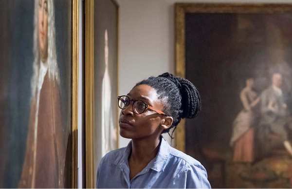 Image of a woman in an Art gallery, viewing an oil painting.